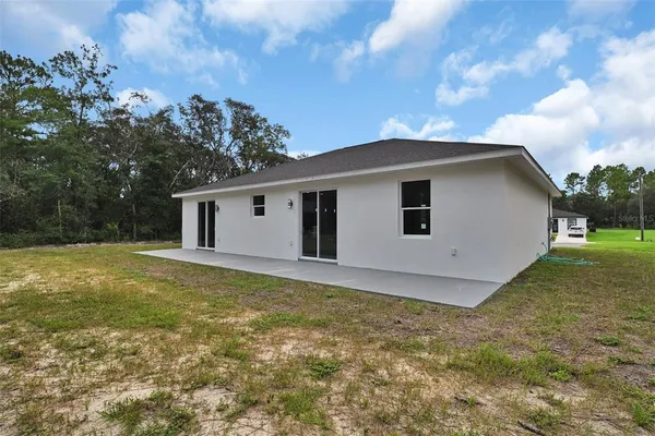 a view of a house with a backyard
