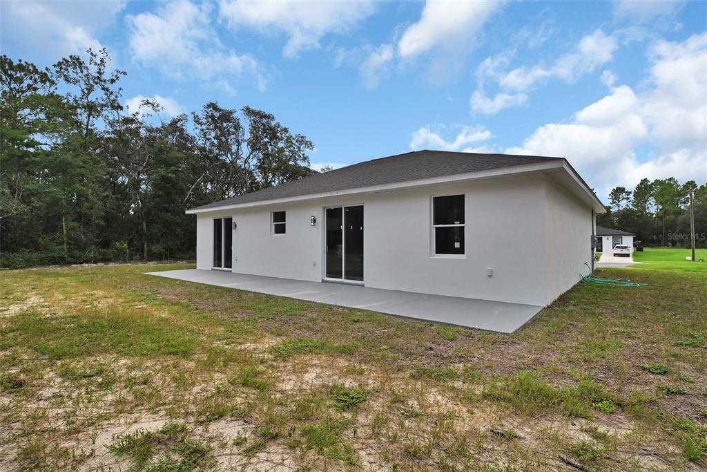 7604 Southwest 103rd Loop Ocala, FL 34476 - Photo 19 of 20 a view of a house with a backyard