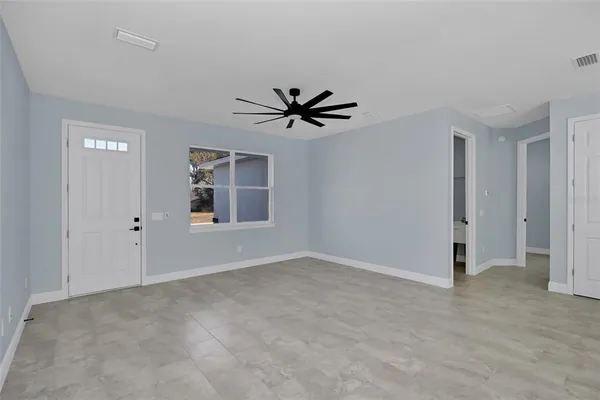 a view of a livingroom with a ceiling fan and window