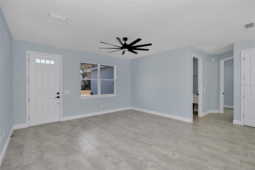 7604 Southwest 103rd Loop Ocala, FL 34476 - Photo 3 of 20 a view of a livingroom with a ceiling fan and window