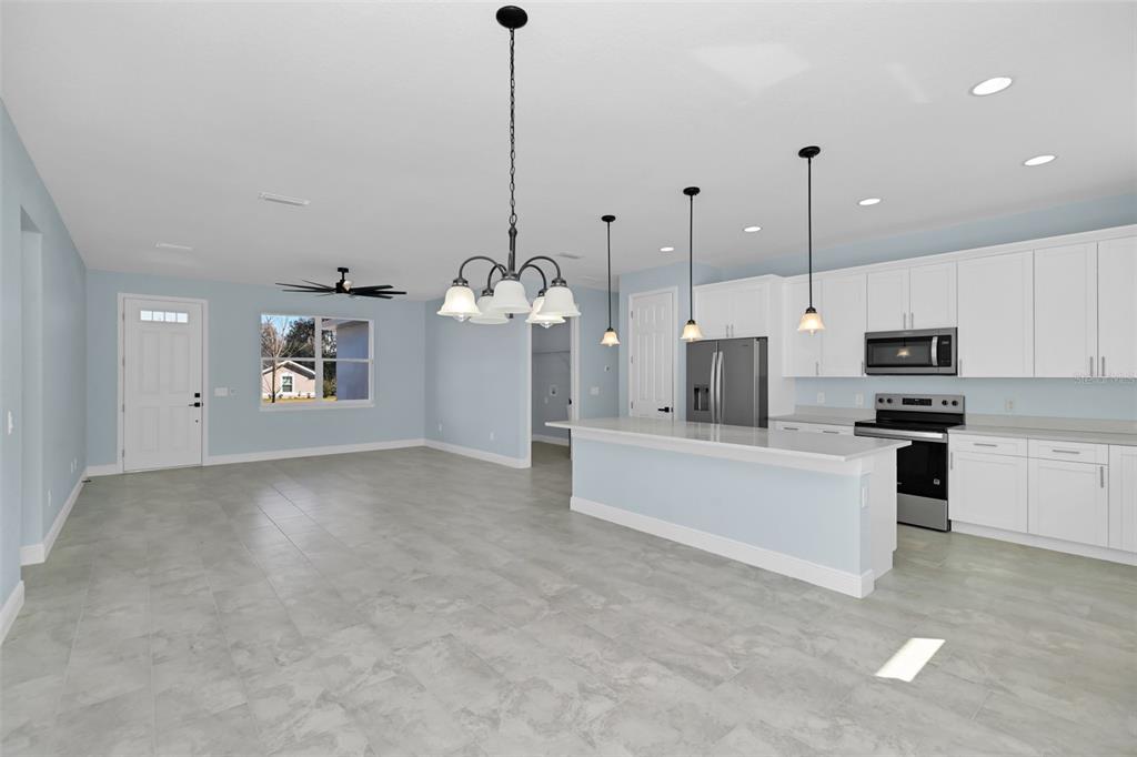 7604 Southwest 103rd Loop Ocala, FL 34476 - Photo 5 of 20 a view of a kitchen with kitchen island a sink stainless steel appliances and a counter top