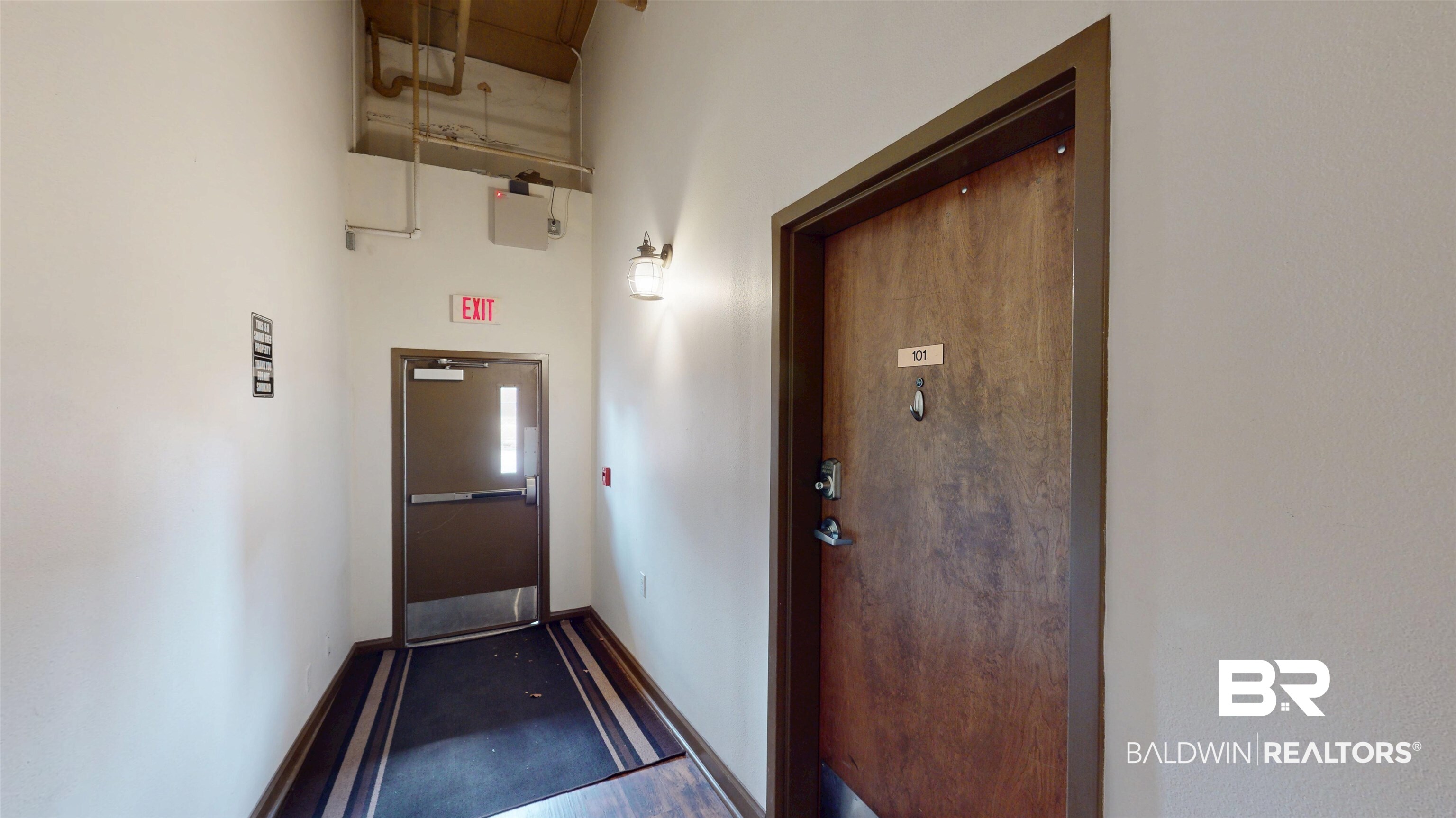 308 St Louis Street, Unit 101 Mobile, AL 36602 - Photo 7 of 30 Doorway featuring baseboards and a high ceiling