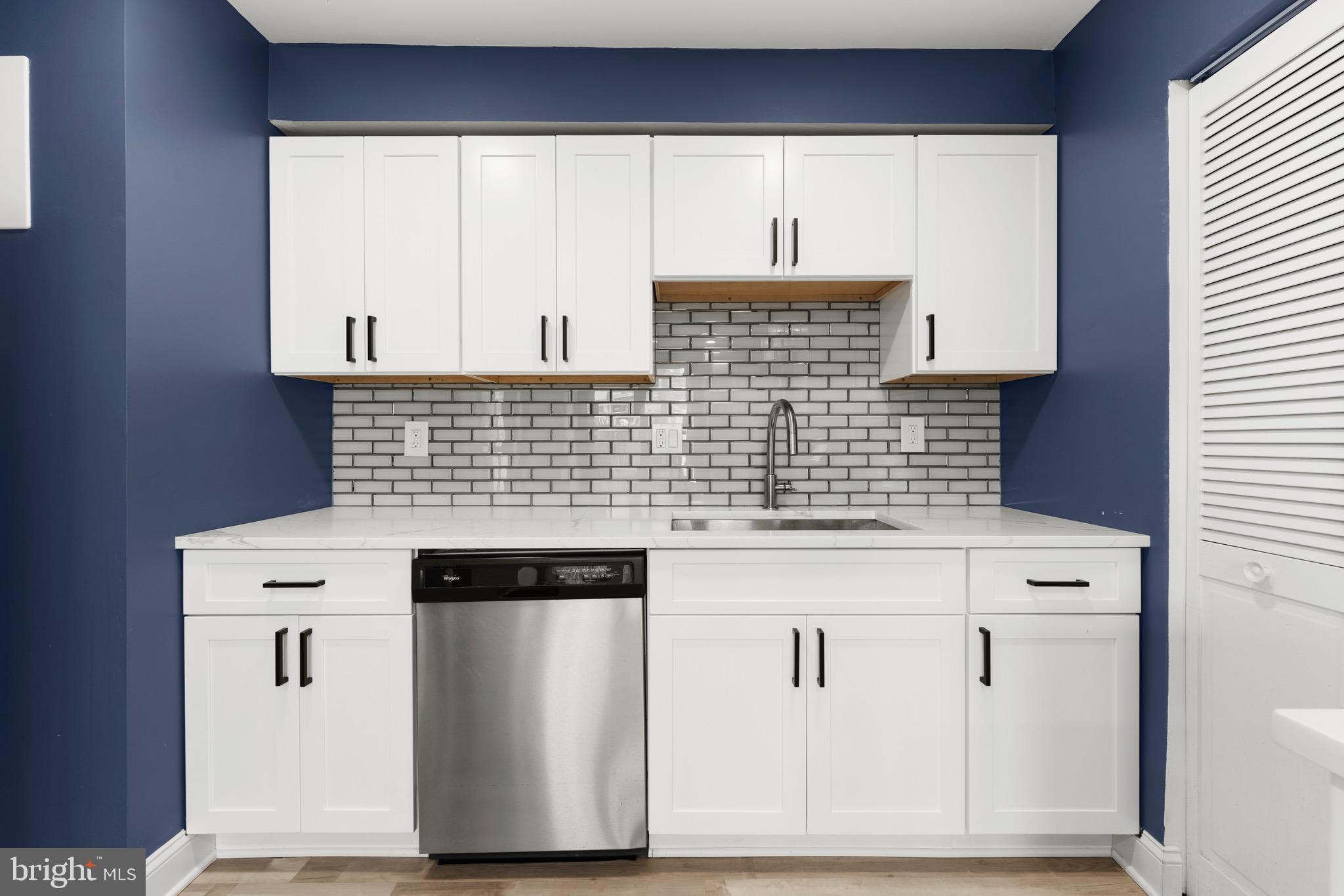 3210 Morning Glory Road Philadelphia, PA 19154 - Photo 8 of 24 a kitchen with white cabinets and a stove