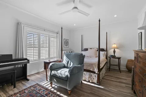 a living room with furniture wooden floor and a lamp