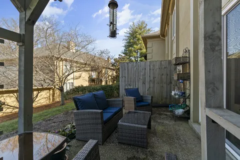 a view of backyard with outdoor seating and plants