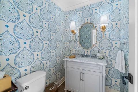 a bathroom with a granite countertop toilet sink and mirror