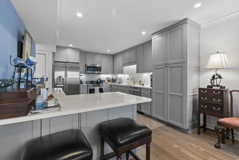 a kitchen with refrigerator and cabinets