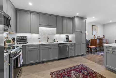 a kitchen with appliances cabinets and furniture