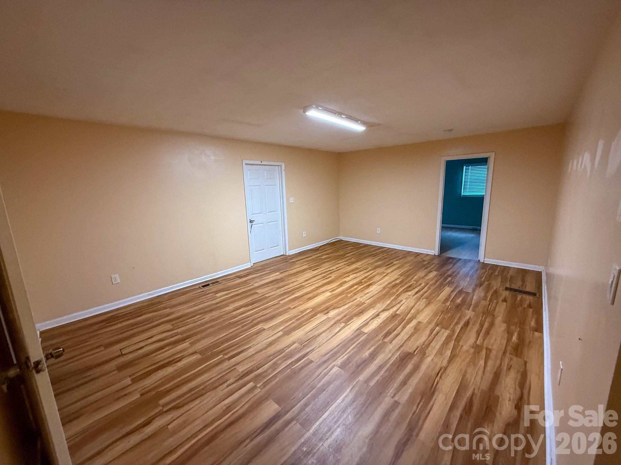 483 Caribou Road Asheville, NC 28803 - Photo 13 of 26 a view of empty room with wooden floor