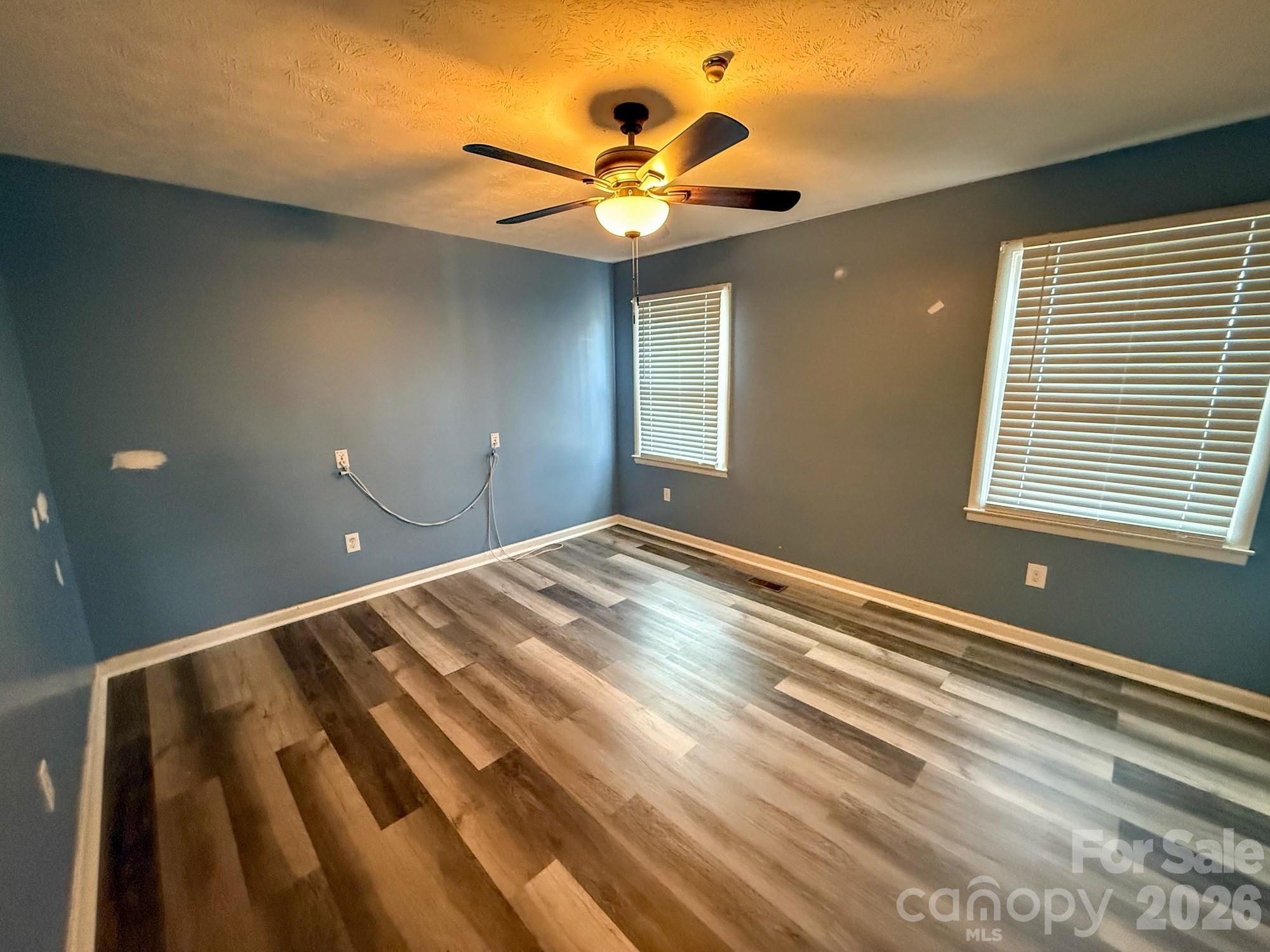 483 Caribou Road Asheville, NC 28803 - Photo 25 of 26 a bedroom with a bed and a chandelier