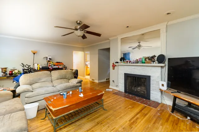 a living room with furniture a flat screen tv and a fireplace