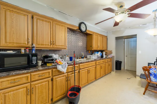 a kitchen with a refrigerator a sink and cabinets