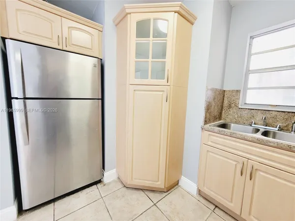 a white refrigerator freezer sitting in a kitchen