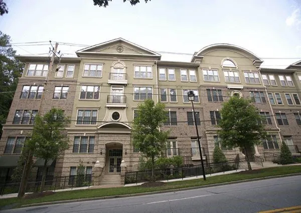 a front view of a residential apartment building with a yard