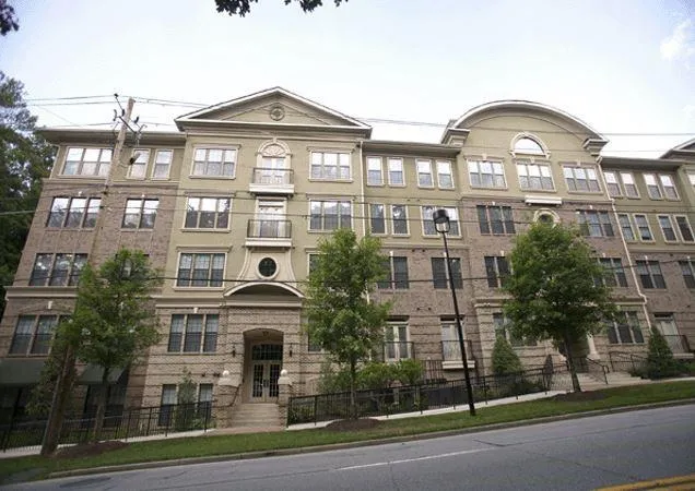 a front view of a residential apartment building with a yard