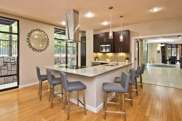 a view of a living room with furniture and wooden floor