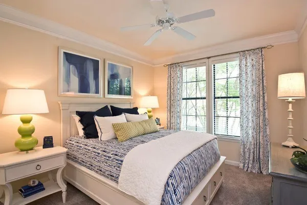 a bedroom with a large bed and a window