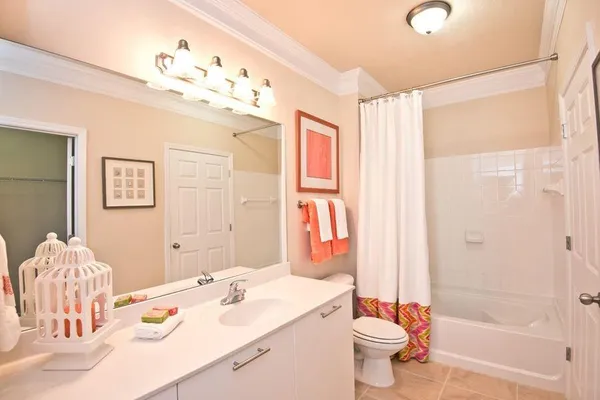 a bathroom with a sink vanity mirror and toilet