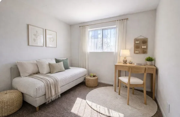 a spacious bedroom with a bed and a potted plant