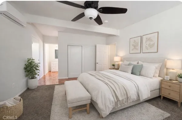 a bathroom with a granite countertop sink a toilet and a mirror