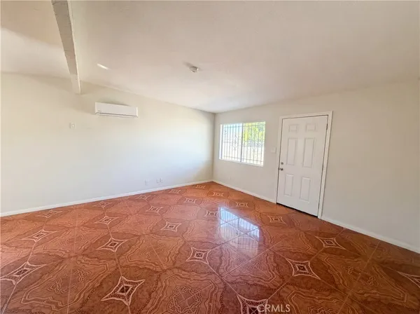 a bedroom with a large bed and wooden floor
