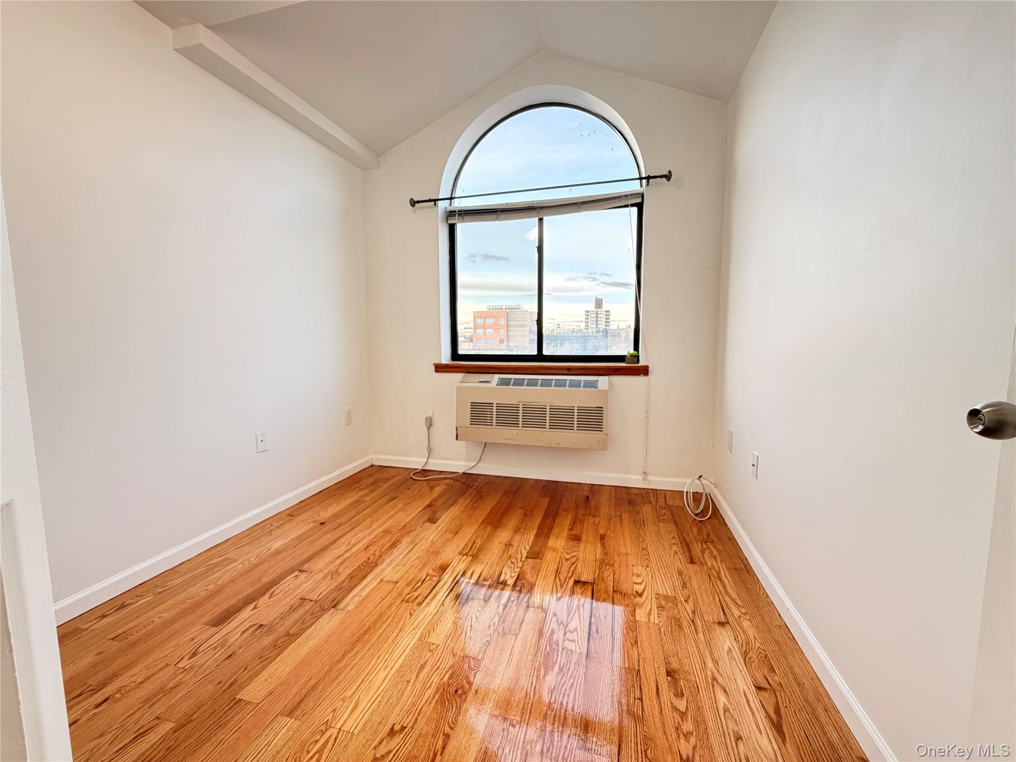 112-26 38th Avenue, Unit 4B Queens, NY 11368 - Photo 11 of 15 a view of empty room with wooden floor and fan