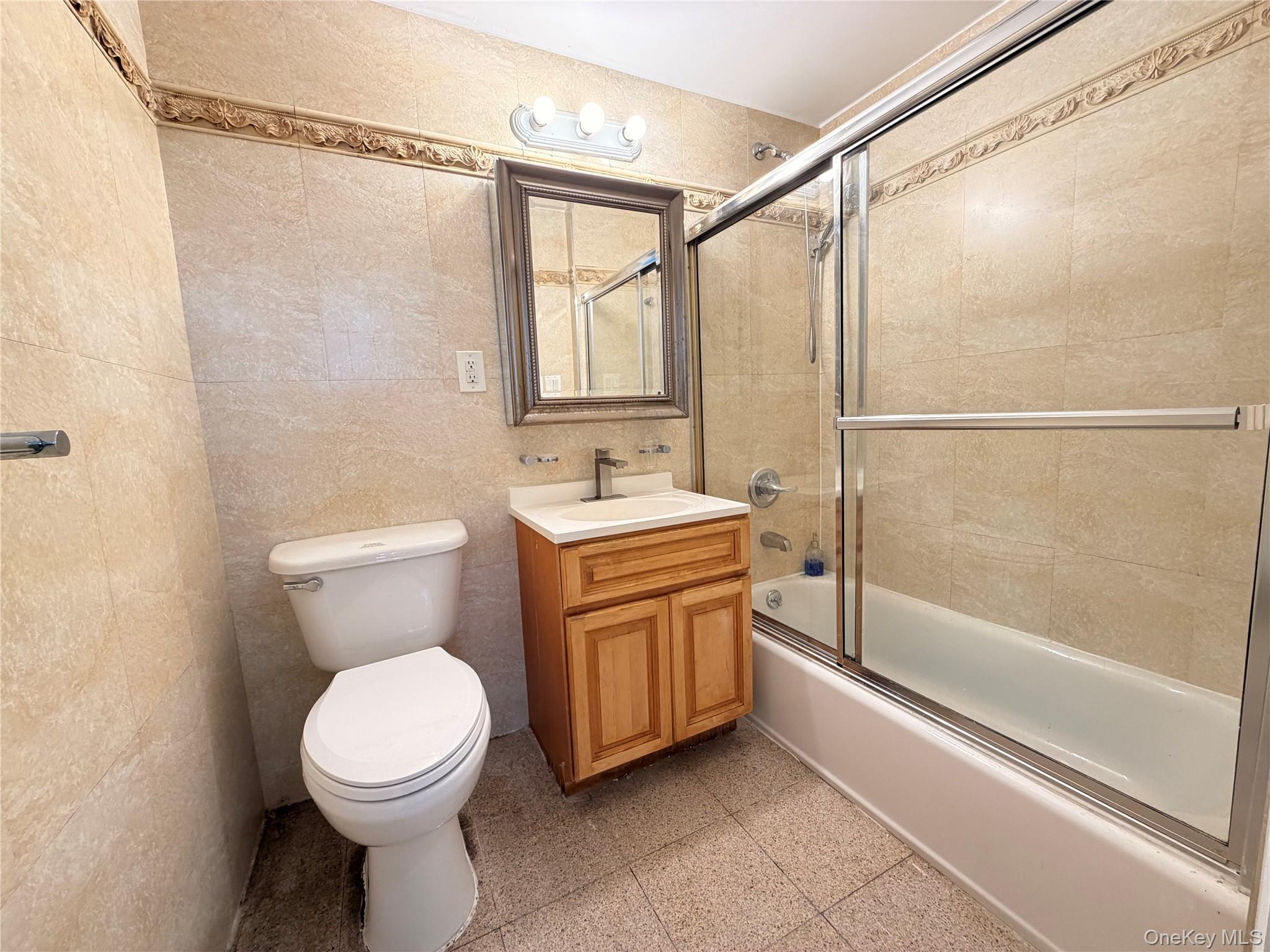 112-26 38th Avenue, Unit 4B Queens, NY 11368 - Photo 12 of 15 a bathroom with a granite countertop sink toilet and shower