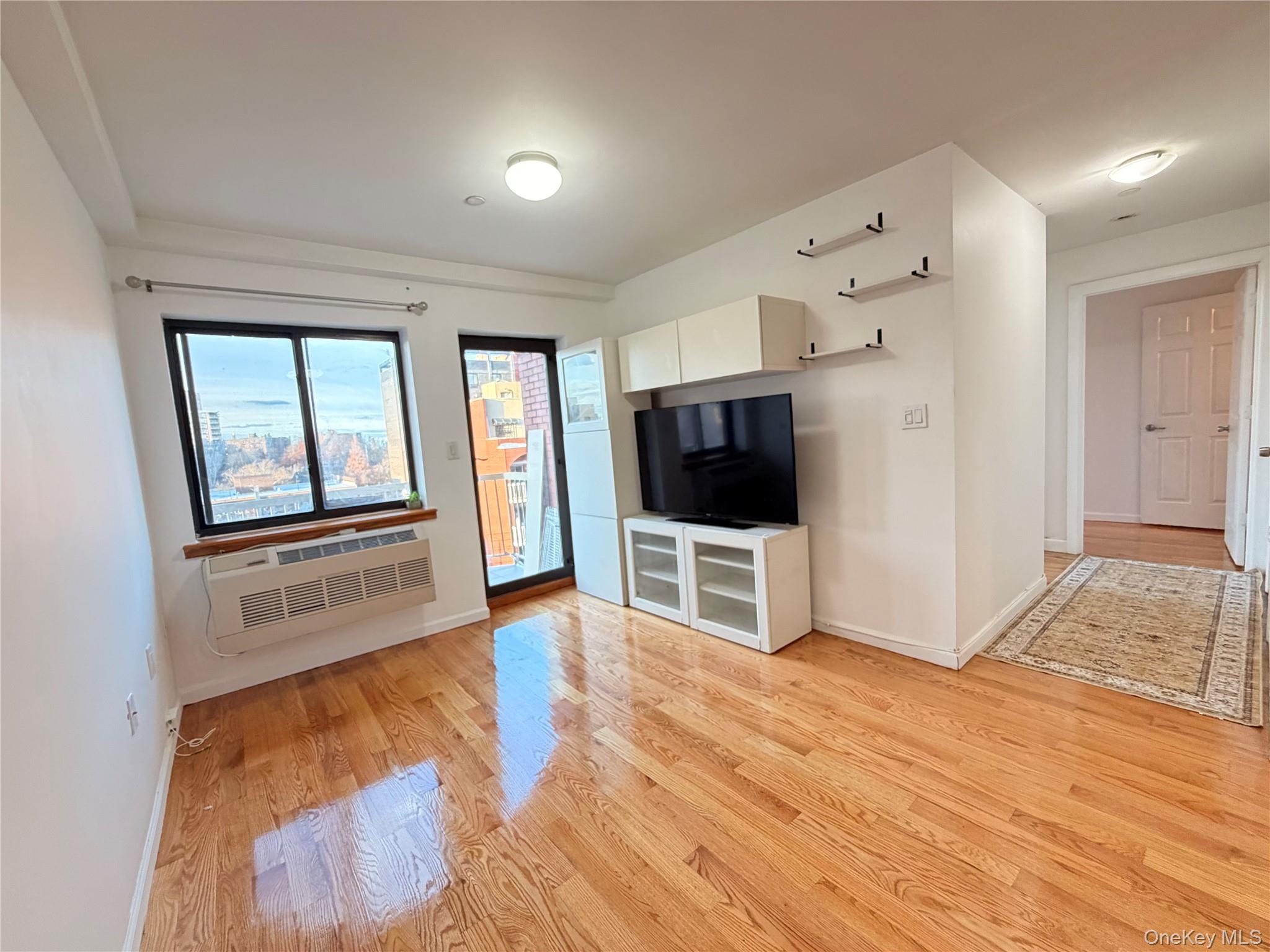 112-26 38th Avenue, Unit 4B Queens, NY 11368 - Photo 6 of 15 a living room with furniture and a flat screen tv