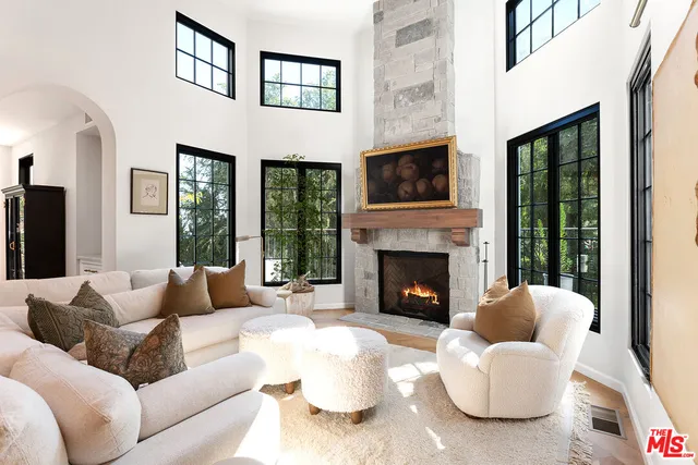 a bedroom with furniture and a large window