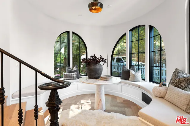 a living room with furniture fireplace and a window