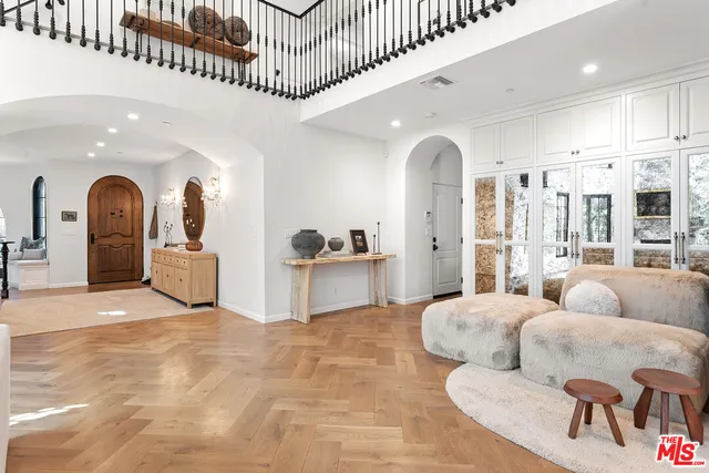 a living room with kitchen island furniture and a chandelier