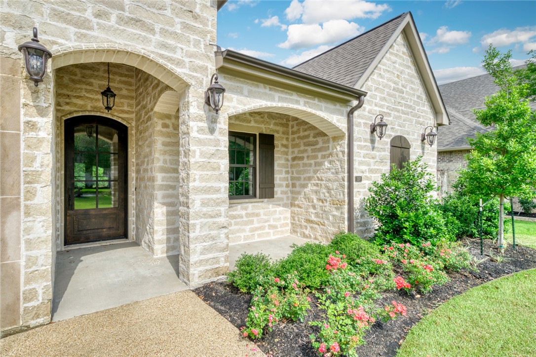 3317 Legacy Court Bryan, TX 77802 - Photo 2 of 28 a front view of a house with garden