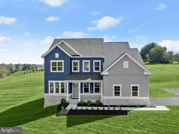 a front view of a house with a garden and yard