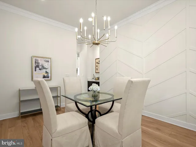 a kitchen with a sink and a stove with wooden floor
