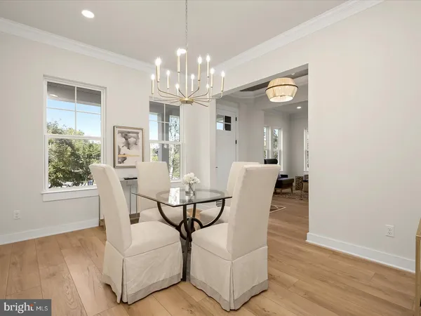 a balcony with wooden floor table and chairs