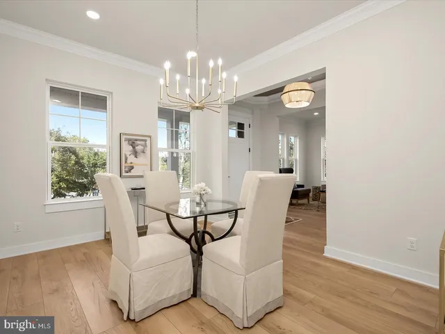 a balcony with wooden floor table and chairs