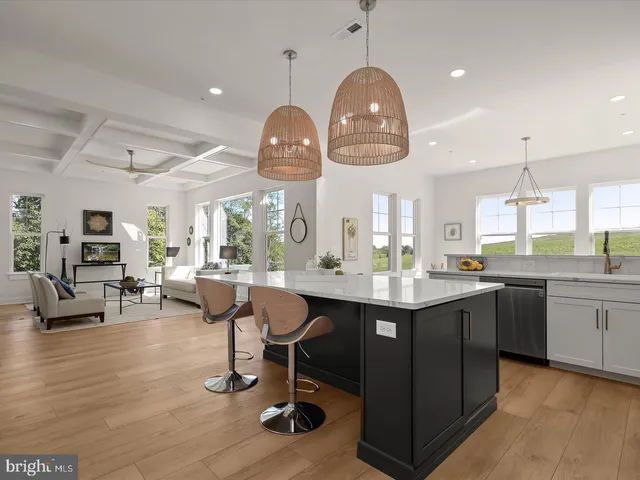 a view of a dining room with furniture large windows and wooden floor