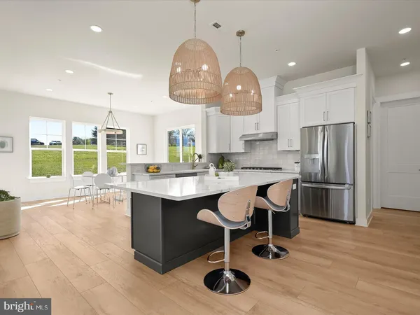 a kitchen with stainless steel appliances granite countertop a refrigerator and a stove
