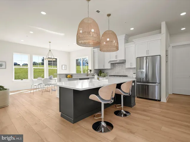 a kitchen with stainless steel appliances granite countertop a refrigerator and a stove