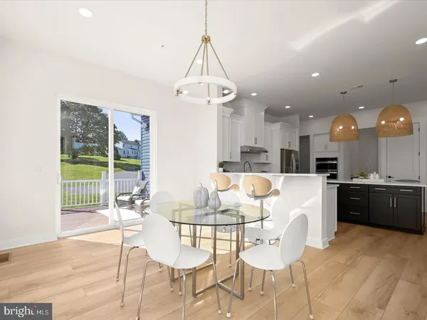 a living room with furniture and a view of kitchen