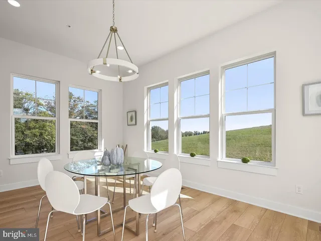a spacious bedroom with a bed a couch and a chandelier