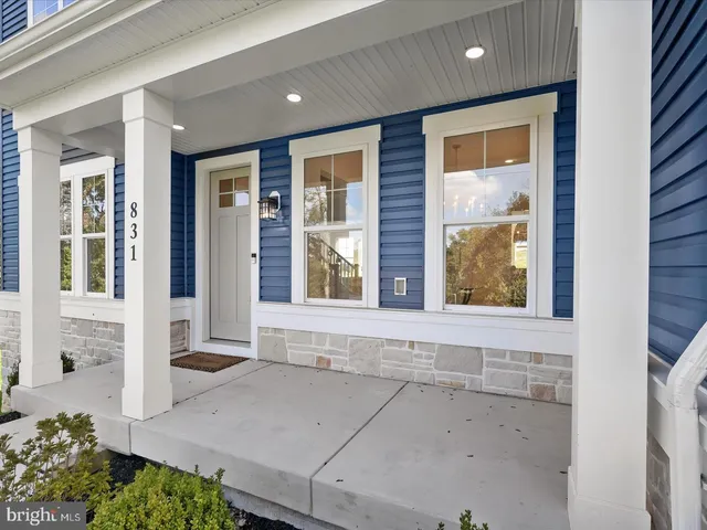 a living room with furniture a rug and a window