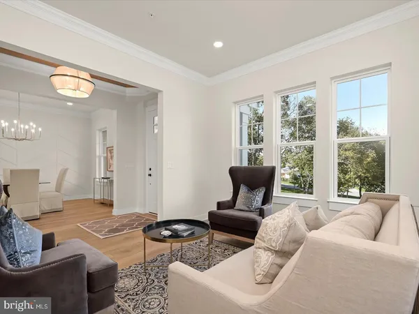 a view of a dining room with furniture and a chandelier