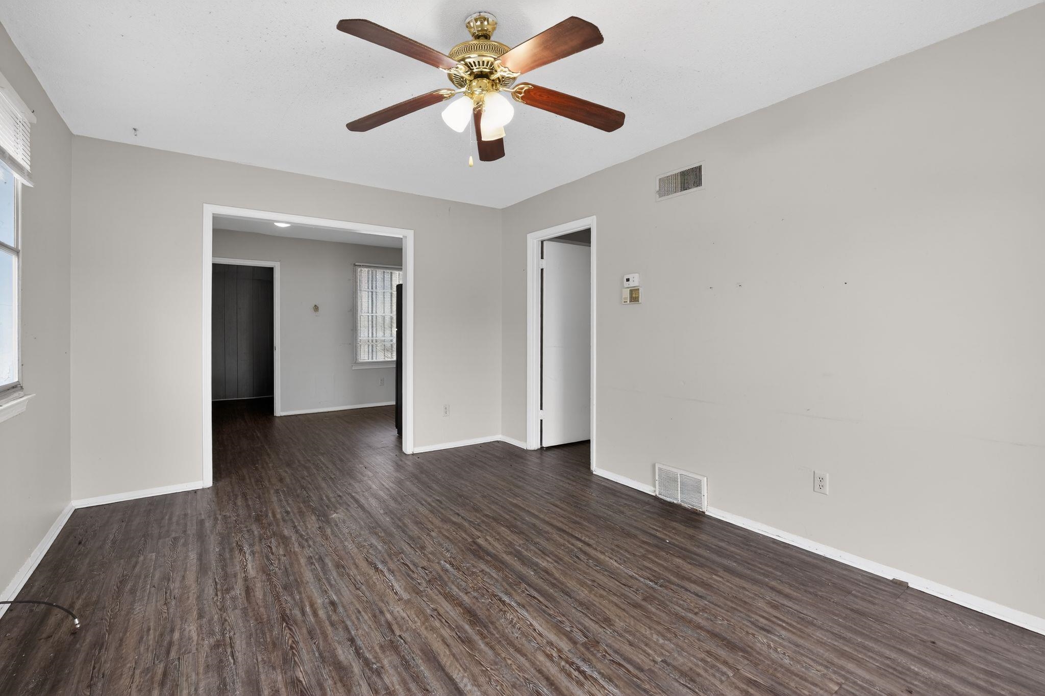3420 Forrester Road Memphis, TN 38109 - Photo 7 of 30 Empty room featuring dark wood-style floors and a ceiling fan