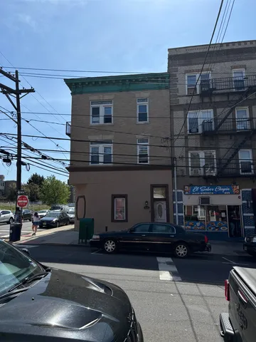 a view of building with cars parked