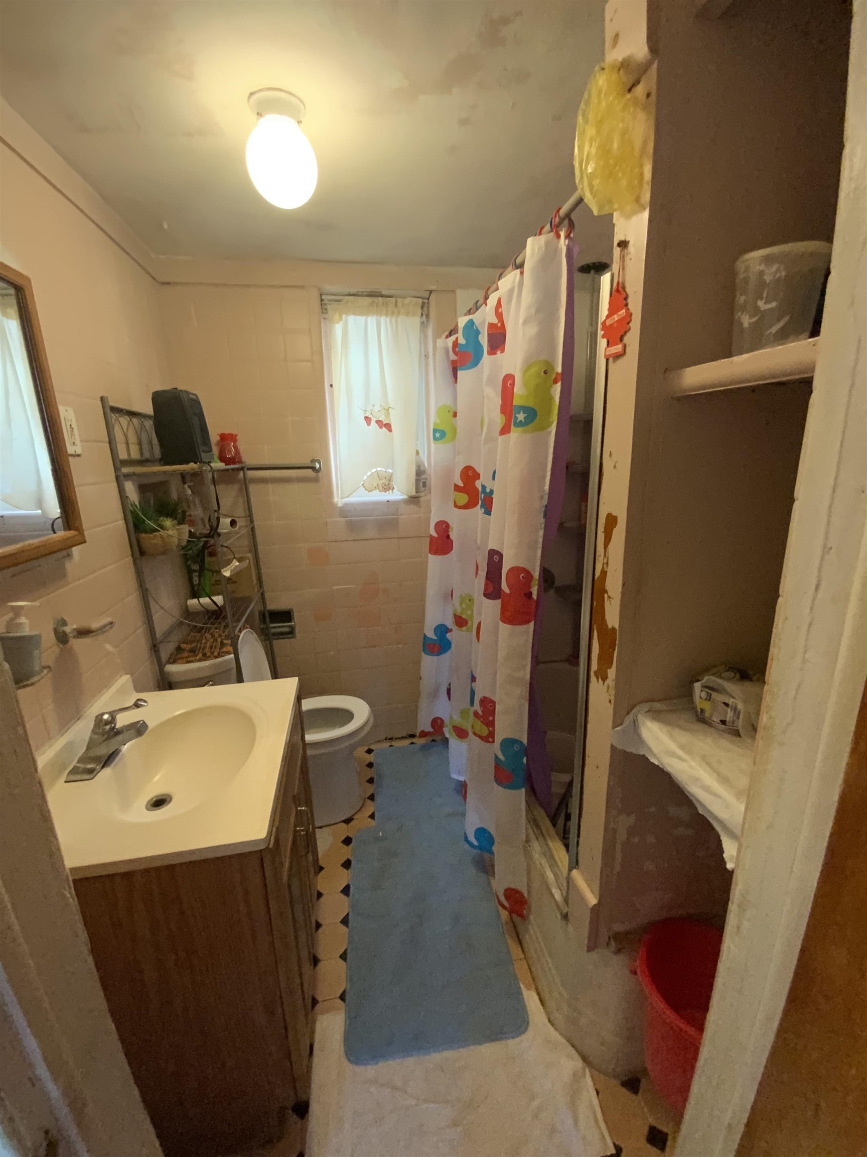 143 64th Street West New York, NJ 07093 - Photo 11 of 16 a bathroom with a sink a toilet and a mirror