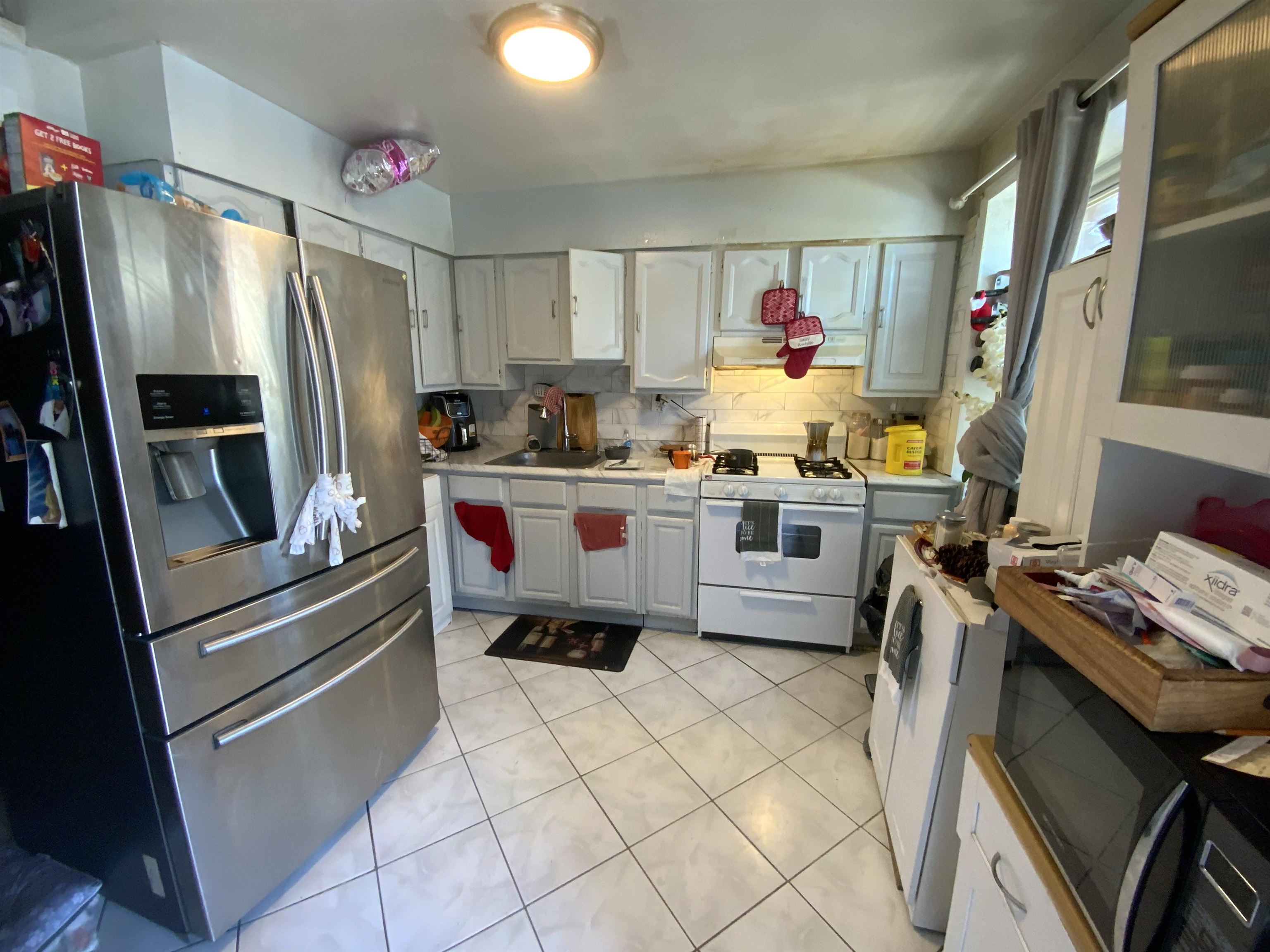 143 64th Street West New York, NJ 07093 - Photo 14 of 16 a kitchen with stainless steel appliances a stove a refrigerator and a refrigerator
