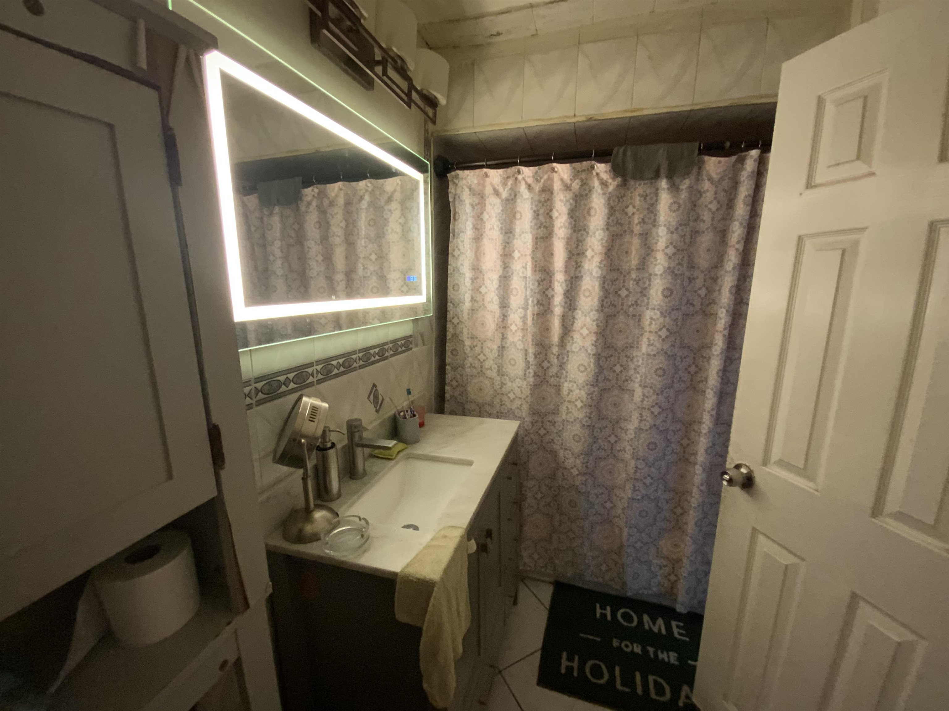 143 64th Street West New York, NJ 07093 - Photo 4 of 16 a bathroom with a sink a toilet and a mirror
