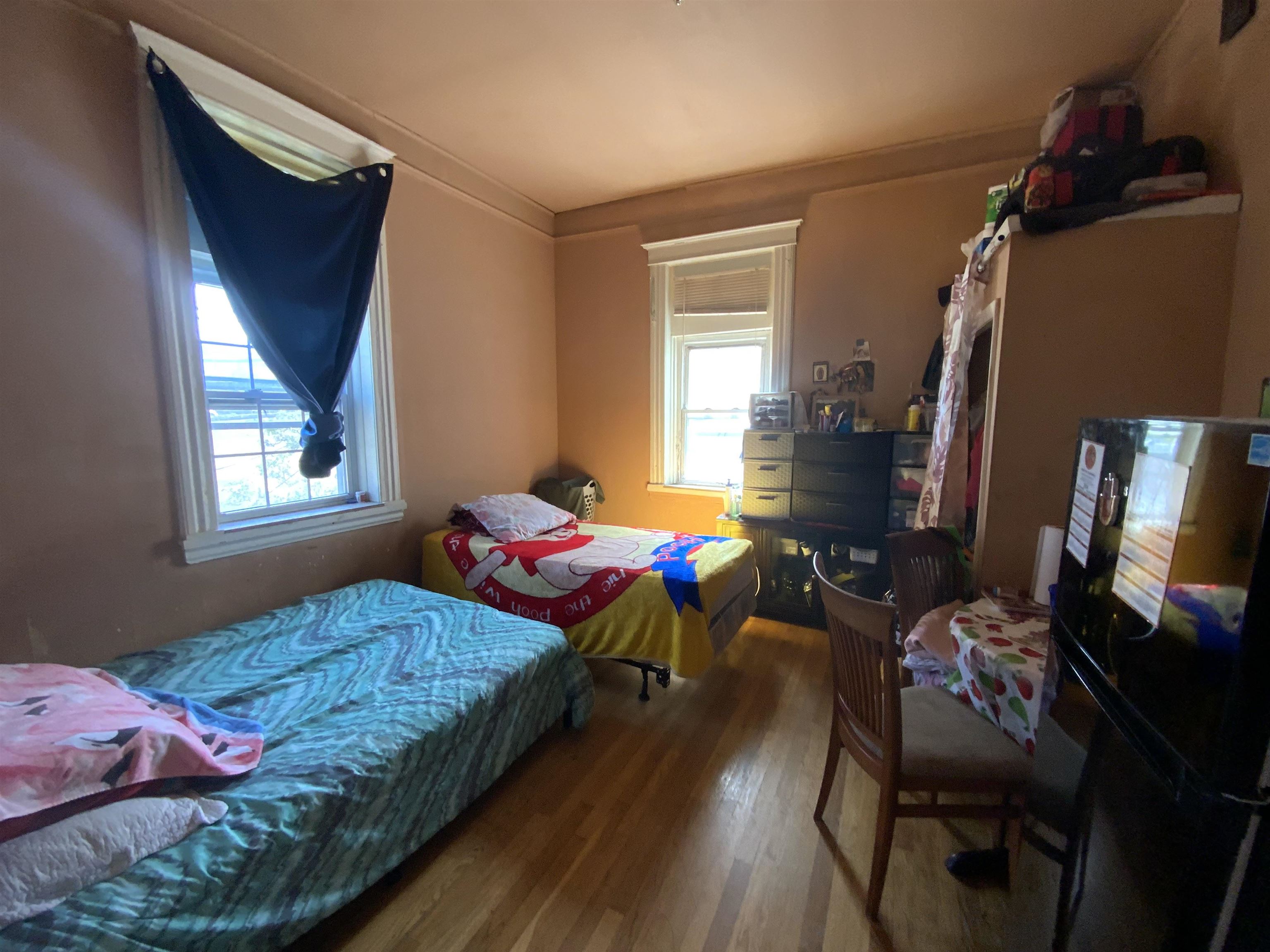 143 64th Street West New York, NJ 07093 - Photo 7 of 16 a bedroom with two beds and a window