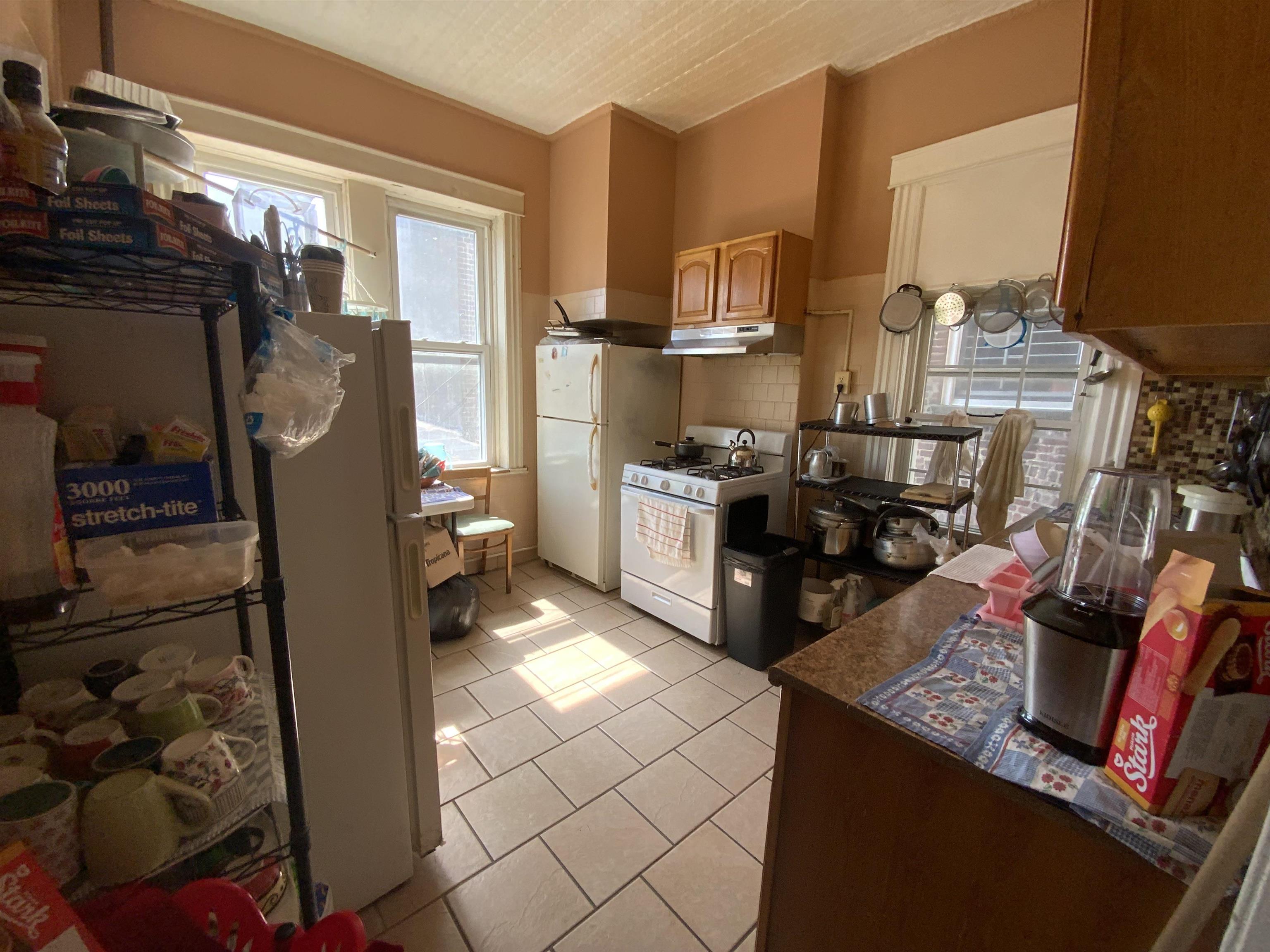 143 64th Street West New York, NJ 07093 - Photo 9 of 16 a kitchen with stainless steel appliances granite countertop a sink stove and cabinets